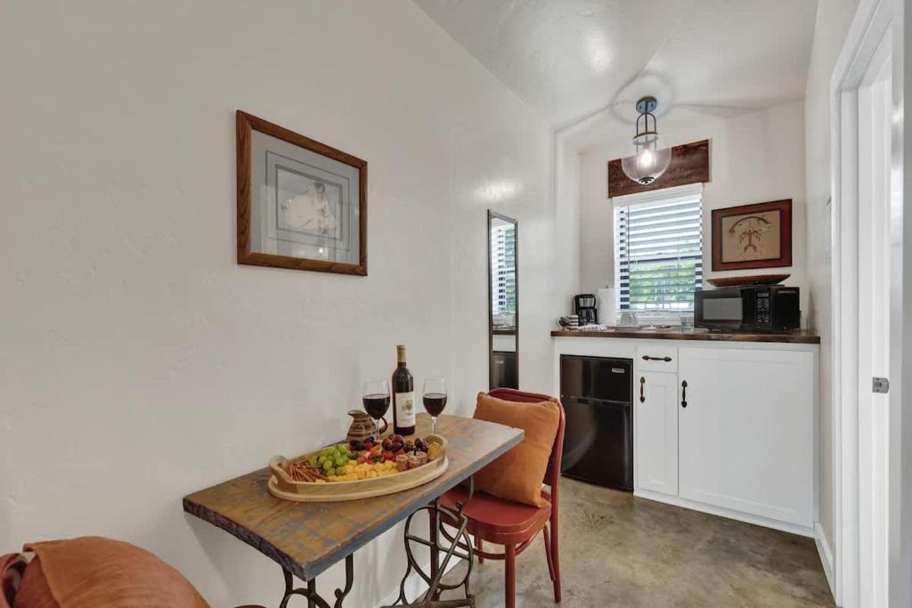 a kitchen with a table with a bowl of fruit on it at Chic Comfort Just Steps from Main Street! in Fredericksburg