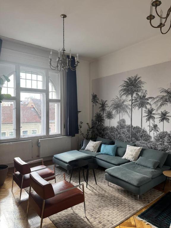 a living room with a couch and a table at The Stage Door Apartment in Debrecen