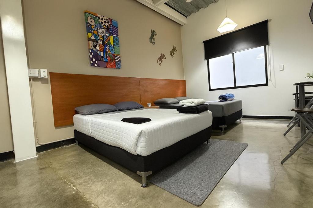 a bedroom with a large bed in a room at Malibu loft hotel in Medellín