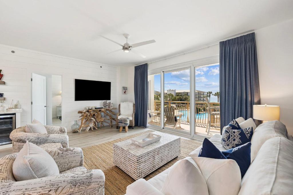 a living room with a couch and a tv at HP 325 Sandy Bottoms by 30A Escapes in Rosemary Beach