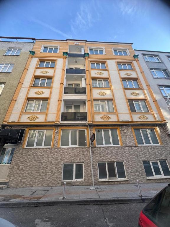 a tall brick building with windows on a street at İlkadım Suit Apart in Samsun