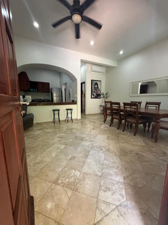 a living room with a ceiling fan and a table at Spacious 3 bedroom Condo by Mamitas beach in Playa del Carmen