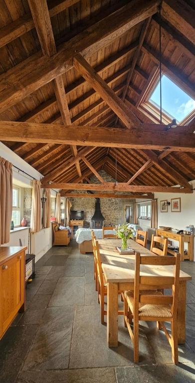 a large room with a wooden table and chairs at Haytor Rocks, Dartmoor escape in Bovey Tracey