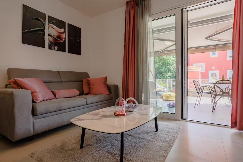 a living room with a couch and a table at Exclusive Apartment MARIJA in Strožanac