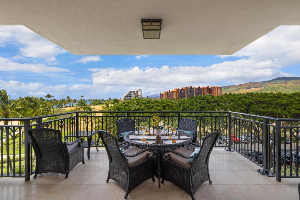a patio with a table and chairs on a balcony at Ko Olina Beach Villas B506 in Kapolei