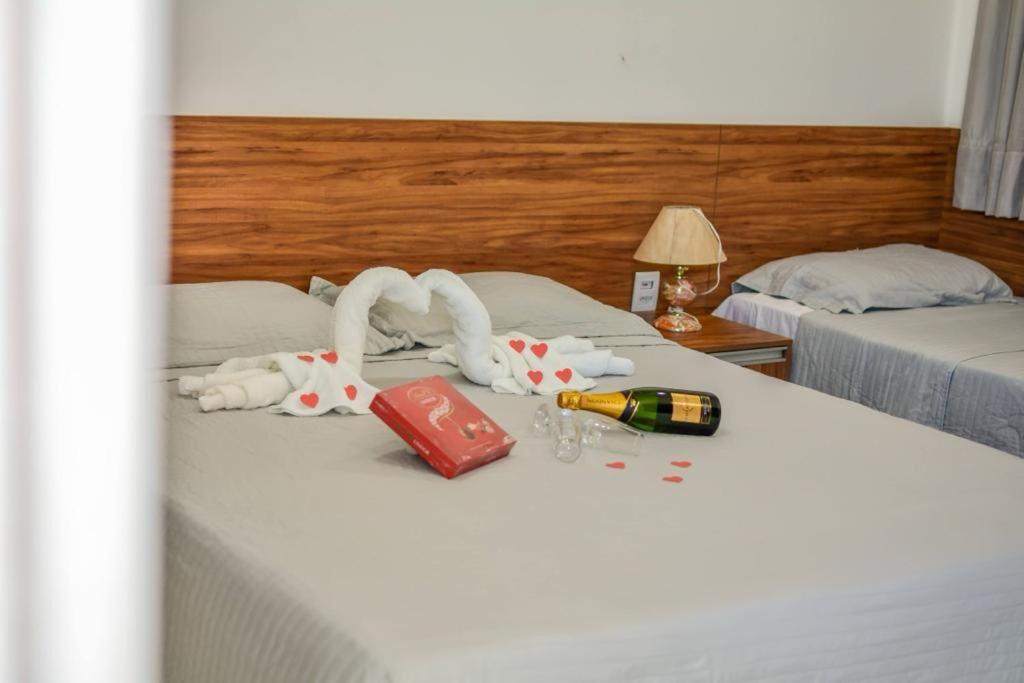 a hotel room with two beds with towels on a bed at Pousada Posto Elite in Água Boa