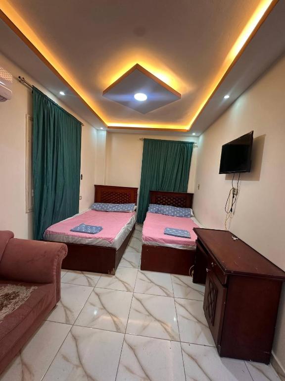 a living room with two beds and a couch at Village chalet in Petra