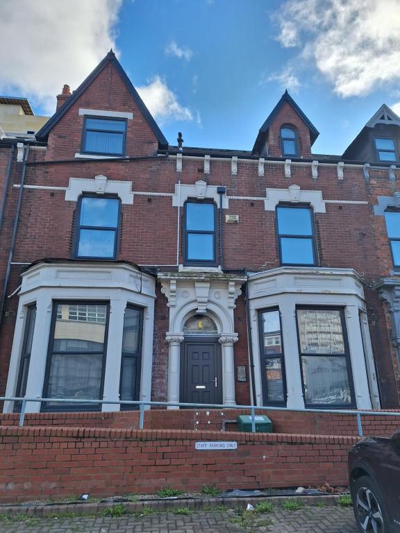 a red brick building with a door on a street at Exclusive Self-contained flat in Middlesbrough in Middlesbrough