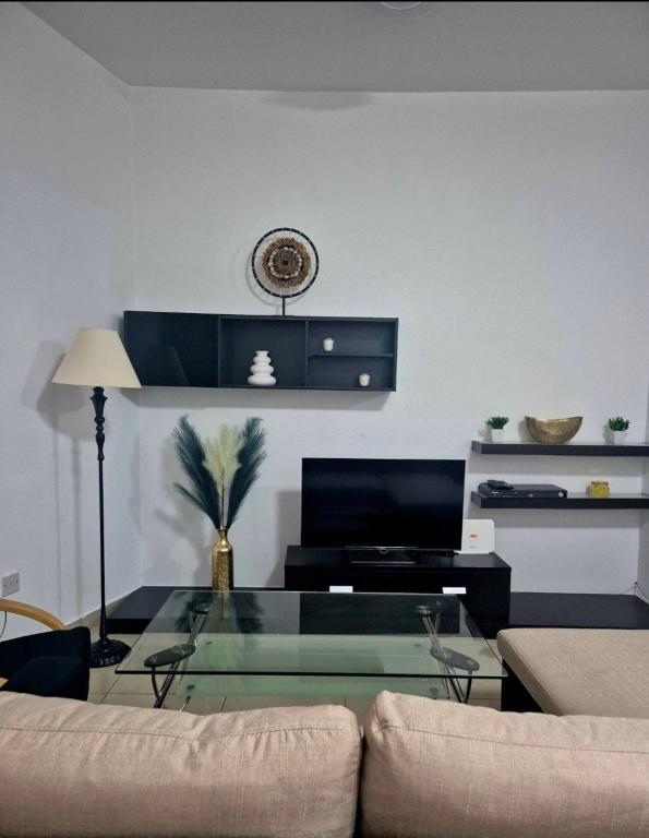a living room with a glass table and a couch at Central 1 BR Retreat in Il-Gżira