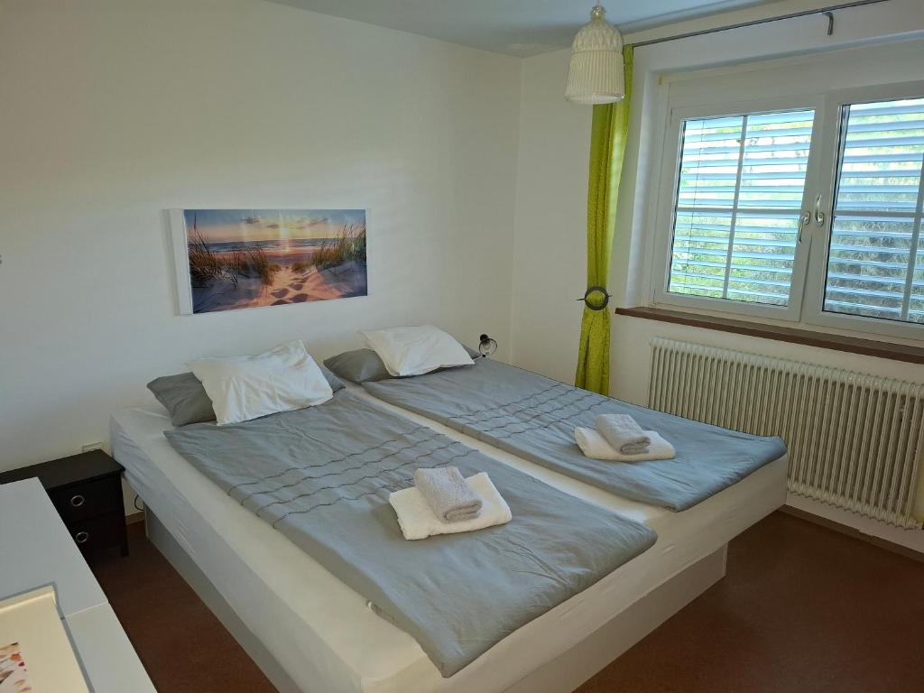 a bedroom with a large bed with towels on it at Bed&Breakfast bei Sabine in Leutschach
