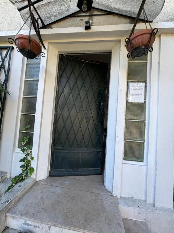 a door to a house with two baskets on it at Résidence Castors Colombes in Colombes