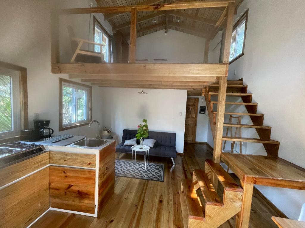 a tiny house with a kitchen and a loft at Jonathans Cabins in Utila