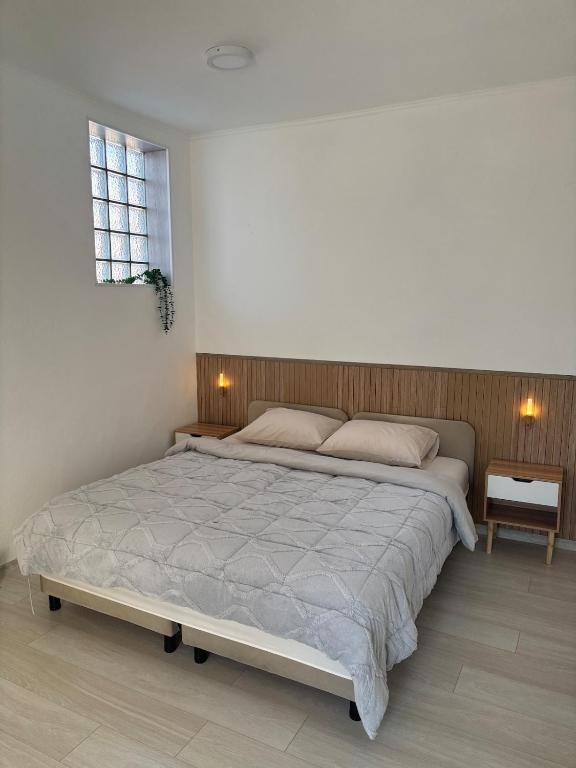 a bedroom with a large bed and a window at Pura Vida Apartment in Mostar
