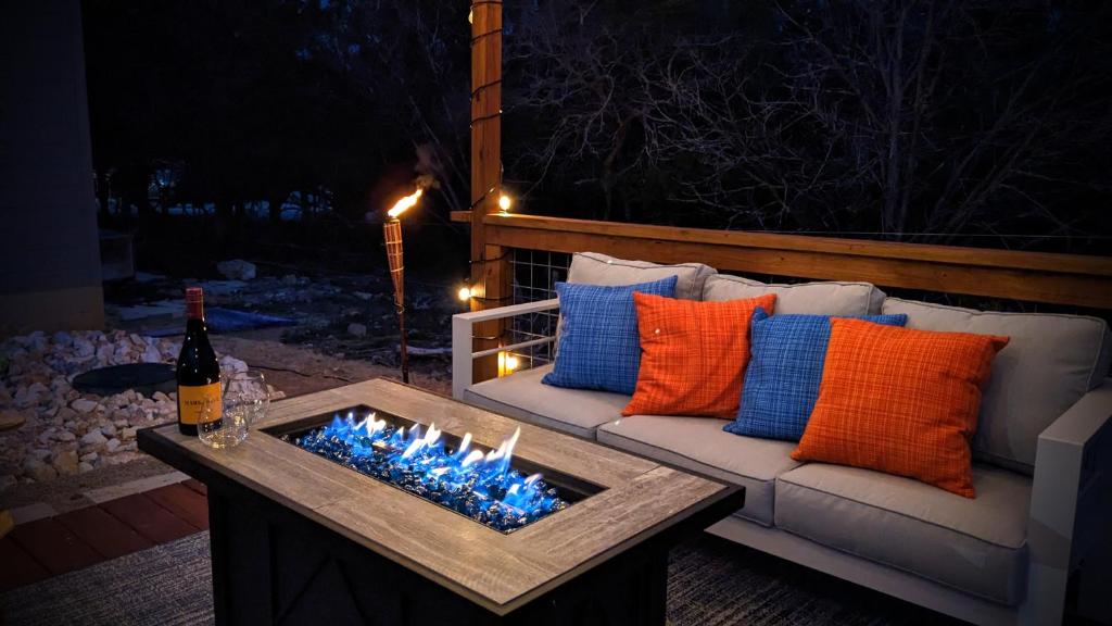 a patio with a couch and a fire pit with lights at A Stunning Escape in Canyon Lake