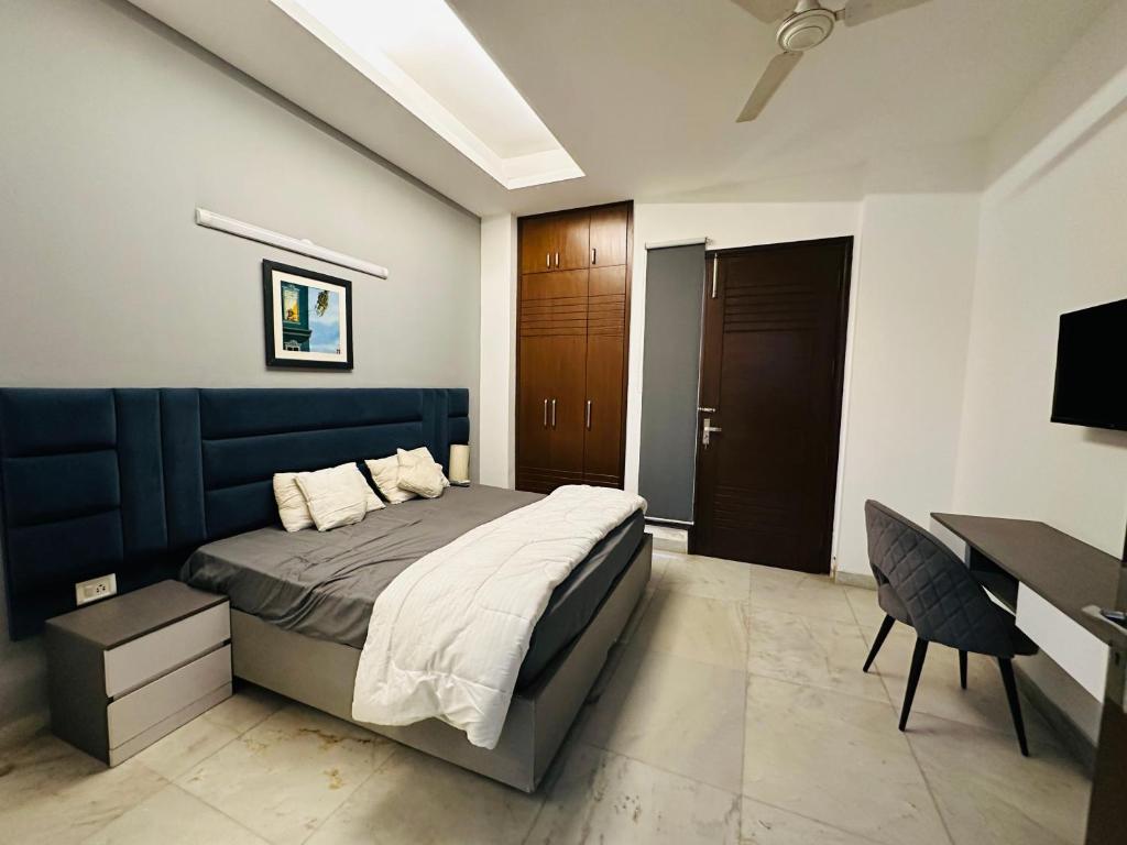 a bedroom with a bed and a desk and a desk at Remix stays in Gurgaon