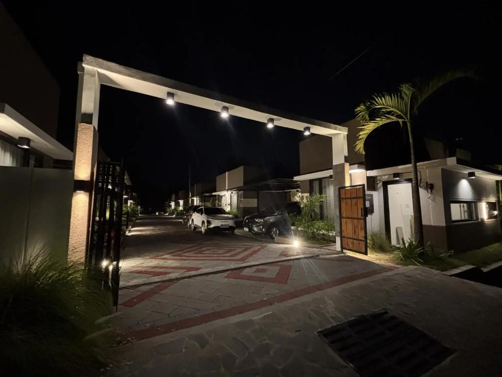 a parking lot with a garage at night at Menata Villa Harmoni in Pakem