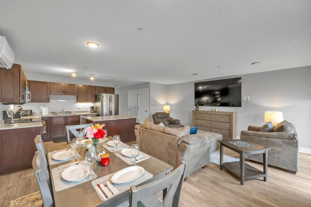 a kitchen and living room with a table and a couch at Modern Birmingham Retreat in Birmingham