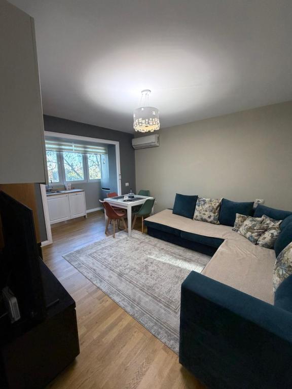 a living room with a couch and a table at Trea Apartment in Tirana