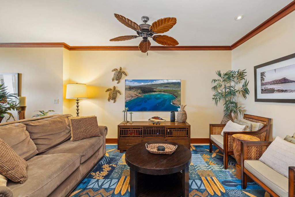 a living room with a couch and a table at Ko Olina Beach Villas O1404 in Kapolei