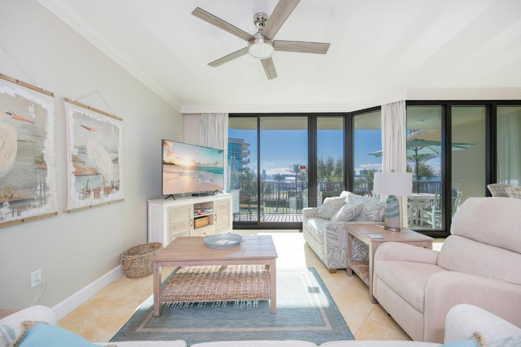 a living room with a couch and a table at Phoenix on the Bay 1206 in Orange Beach
