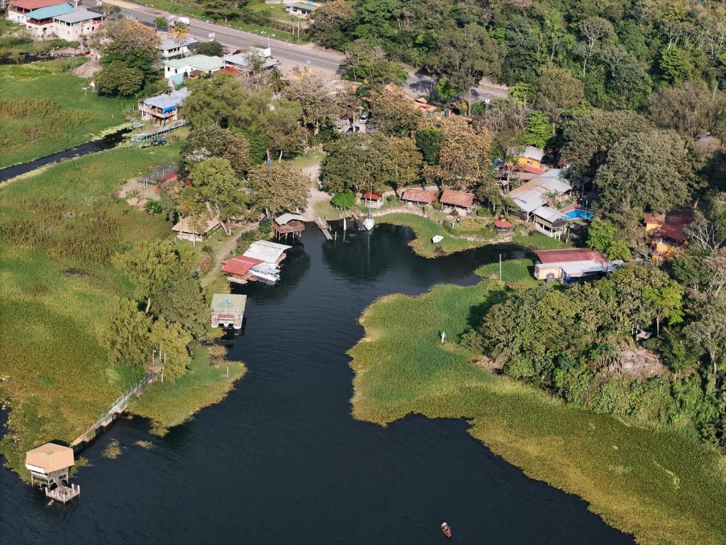 an aerial view of a river with houses and trees at Honduyate in Las Marías