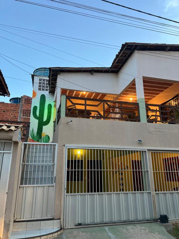 a building with a cactus on the side of it at Casa Maré in Aracati