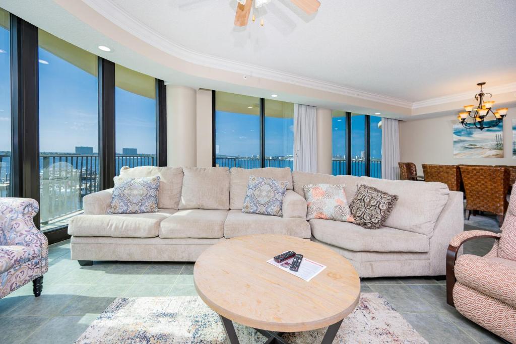 a living room with a couch and a table at Phoenix on the Bay 1303 condo in Orange Beach