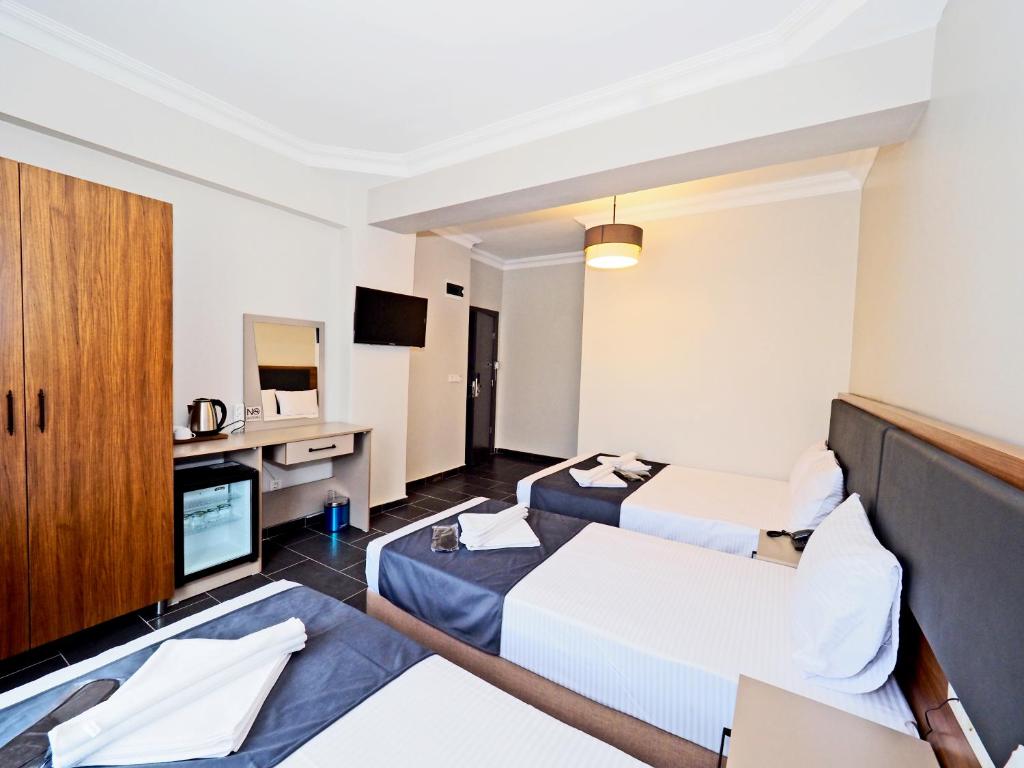 a hotel room with two beds and a tv at diamond premium hotel in Istanbul