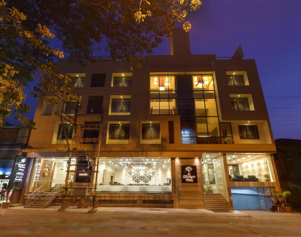 a building with a store front at night at Hotel Silver Oak 7 Minutes Walk to Mahalaxmi Temple in Kolhapur