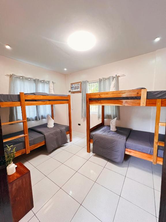 a room with three bunk beds in it at Lio house in El Nido