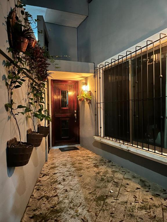 a hallway with potted plants next to a door at Casa Papalo in Palenque