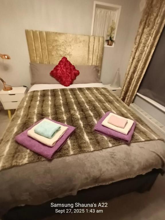 a bedroom with a bed with two pillows on it at Shauna's house in Poole