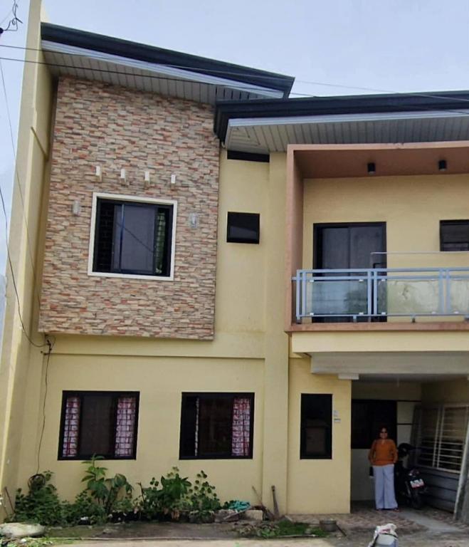 a woman standing in front of a house at Rweydz Guest Inn in Tagbilaran City