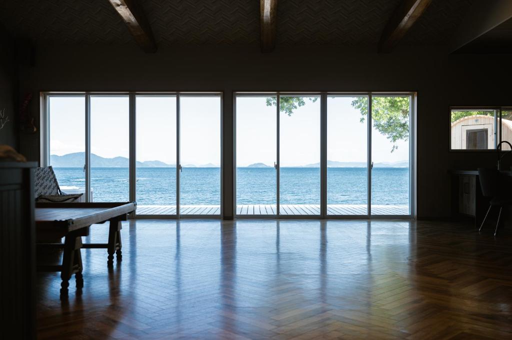an empty living room with a view of the ocean at RIPSTICK Private Luxury Resort in Otsu