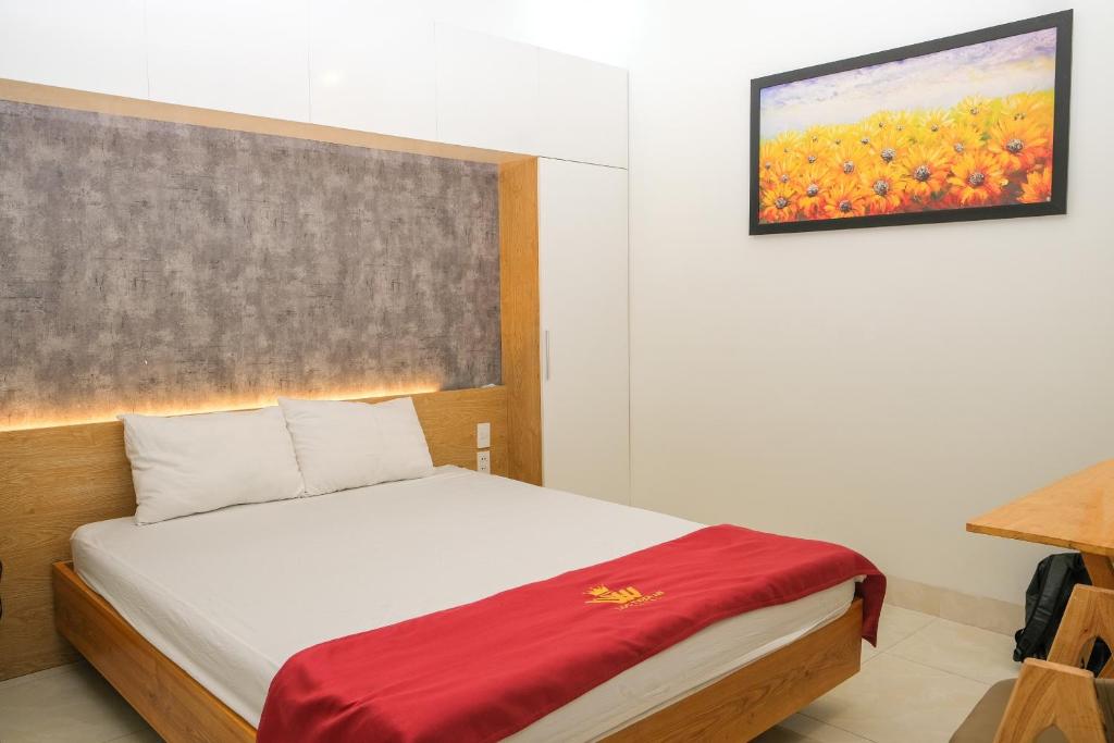 a bedroom with a bed and a painting on the wall at Lộc Thiên Ân hotel in Bien Hoa