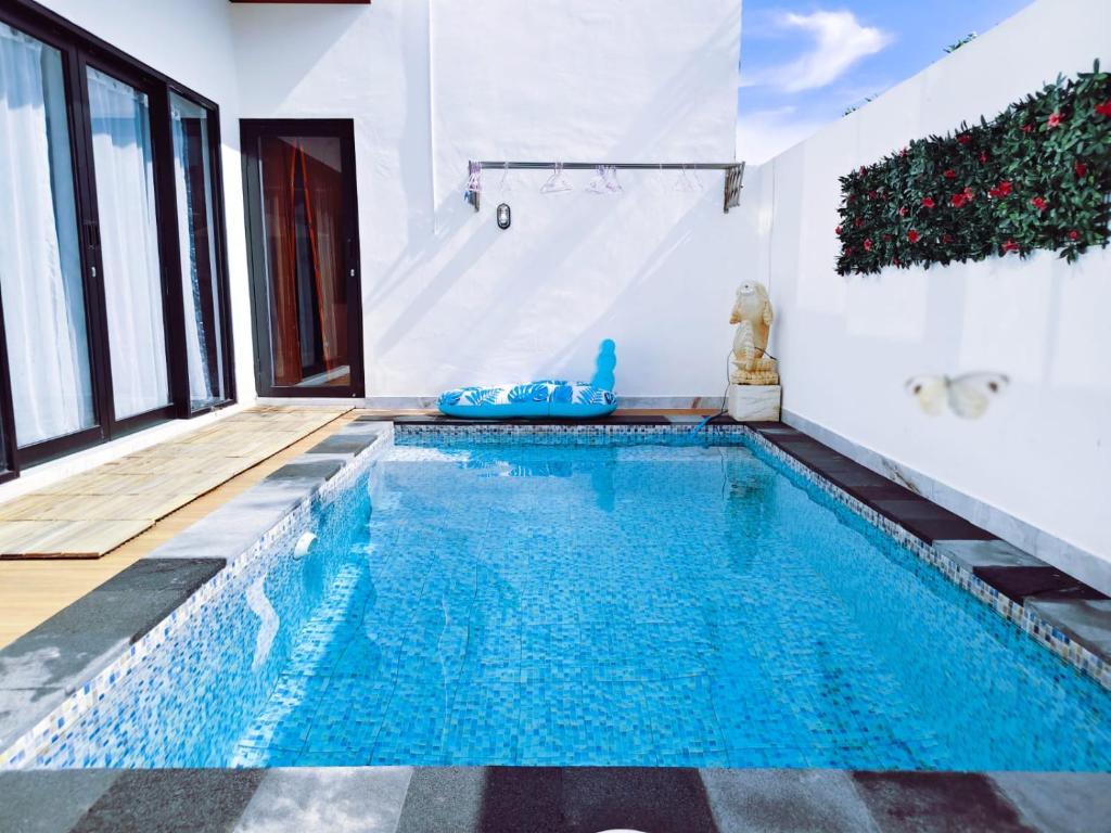a swimming pool in a house at Joy Pool House in Kuta