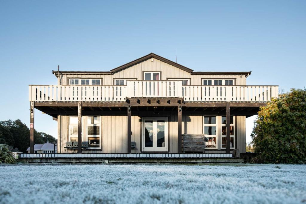 a large house with a deck on top of it at Kaha Lodge in Rangataua