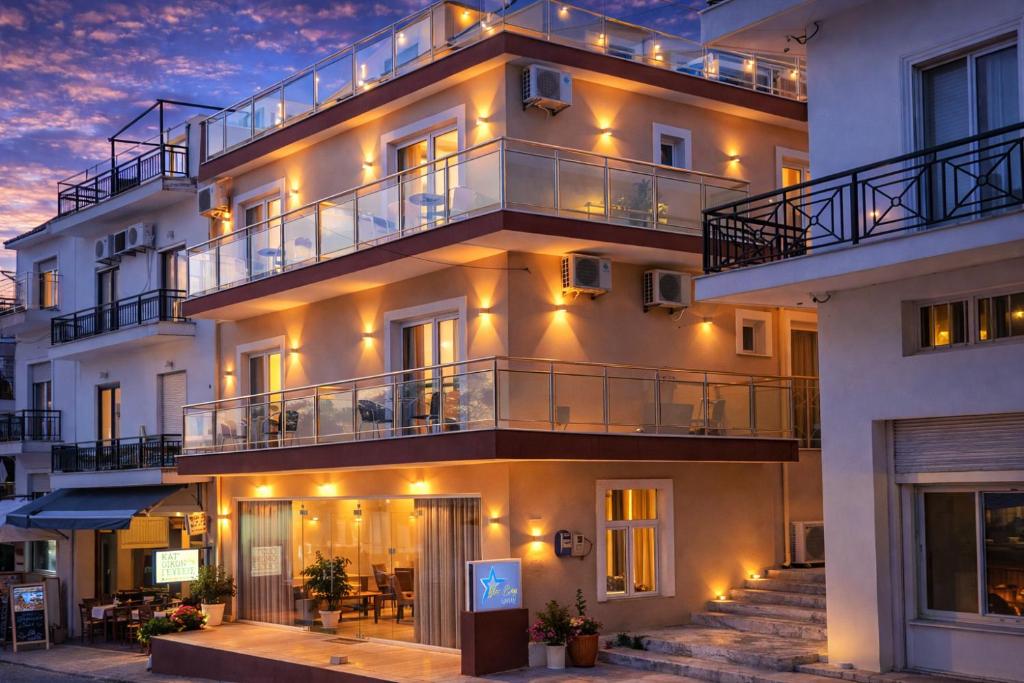 a building with balconies and lights on it at Star Bay Luxury in Limenaria