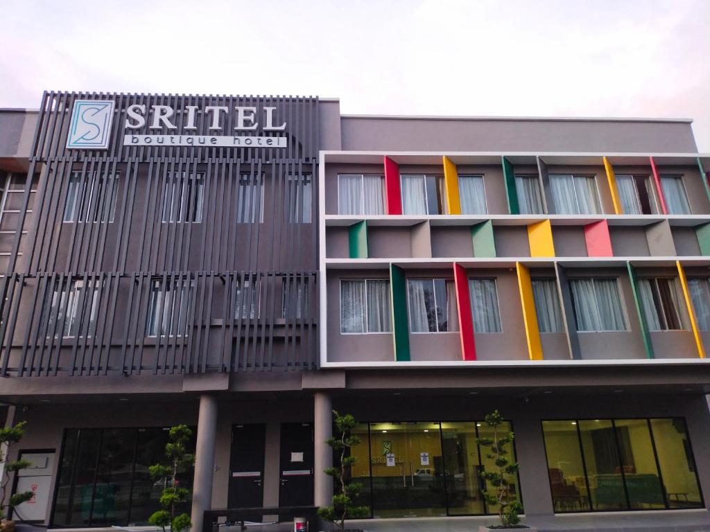 a building with colorful windows and a sign on it at SRITEL BOUTIQUE HOTEL in Shah Alam