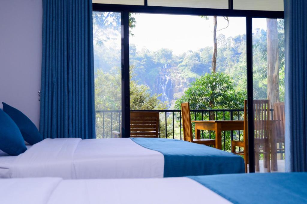 a bedroom with two beds and a balcony with a view at Ella Breathing Space in Ella