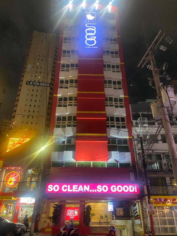 a tall building with a sign on it at night at Hotel Sogo Makati Avenue in Manila