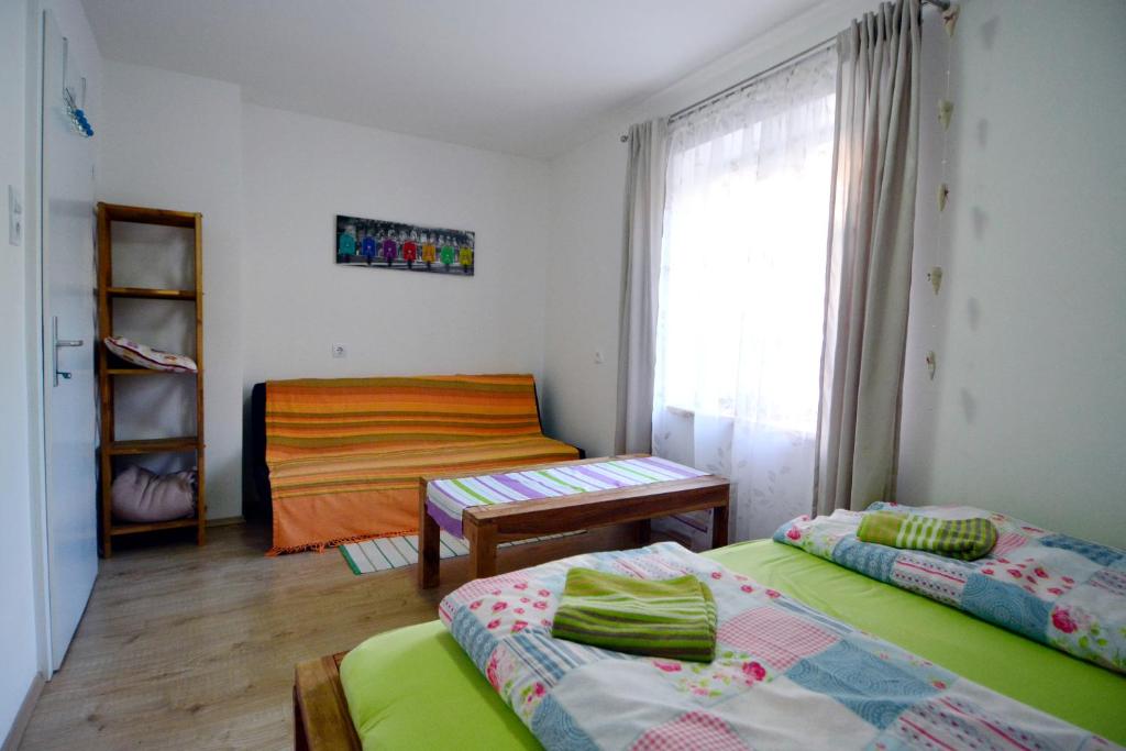 a small room with two beds and a window at Appartement Veronika in Öblarn