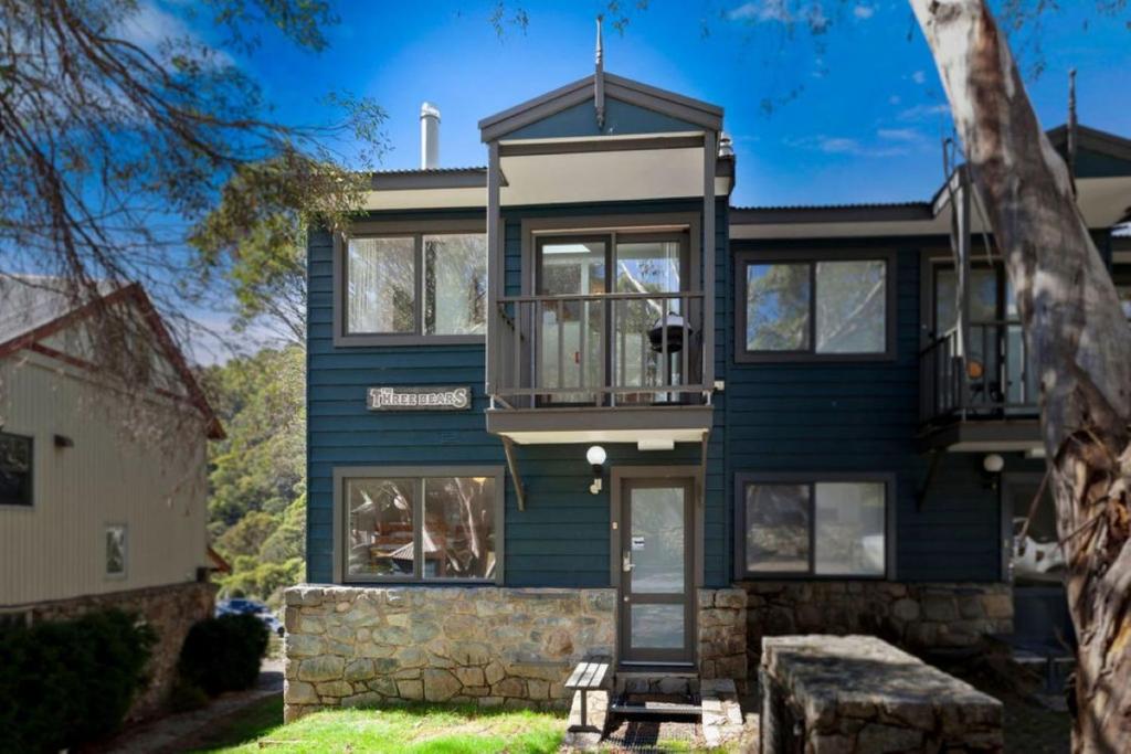 a house with blue siding and windows at Three Bears 3 - Thredbo in Thredbo