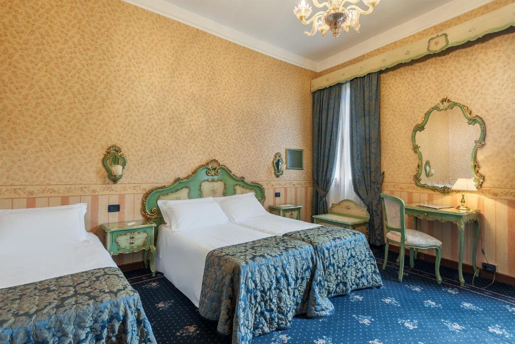 Postel nebo postele na pokoji v ubytování Hotel Montecarlo