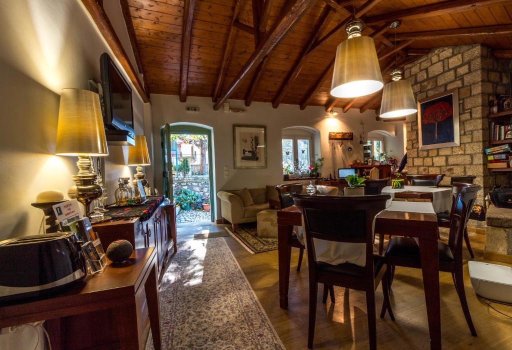 Enastron Guesthouse في ديميتسانا: مطبخ وغرفة معيشة مع طاولة وكراسي