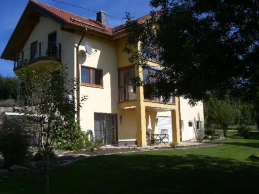 ein großes weißes Haus mit einem Hof davor in der Unterkunft Ferienwohnung Pliefke in Winringen