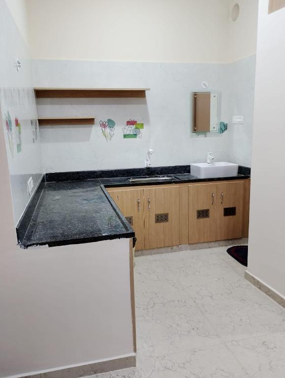 a kitchen with a sink and a counter top at RV Comforts in Perambalūr