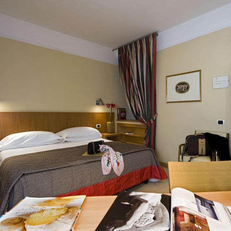 Postel nebo postele na pokoji v ubytování Hotel De Petris