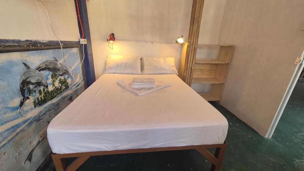 a bed in a room with a painting on the wall at Lucy's Diner Hostel Cafe in San Francisco