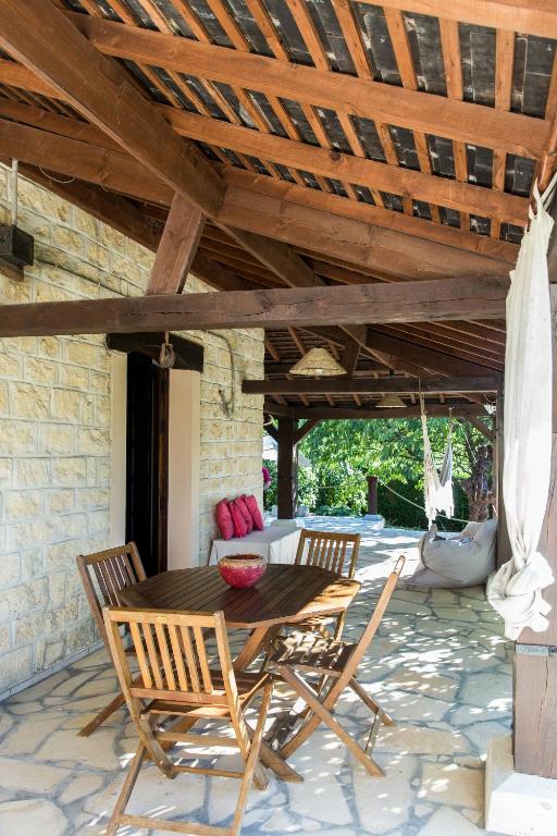 a wooden table and chairs on a patio at Maison Eureka Chantilly Gouvieux in Gouvieux